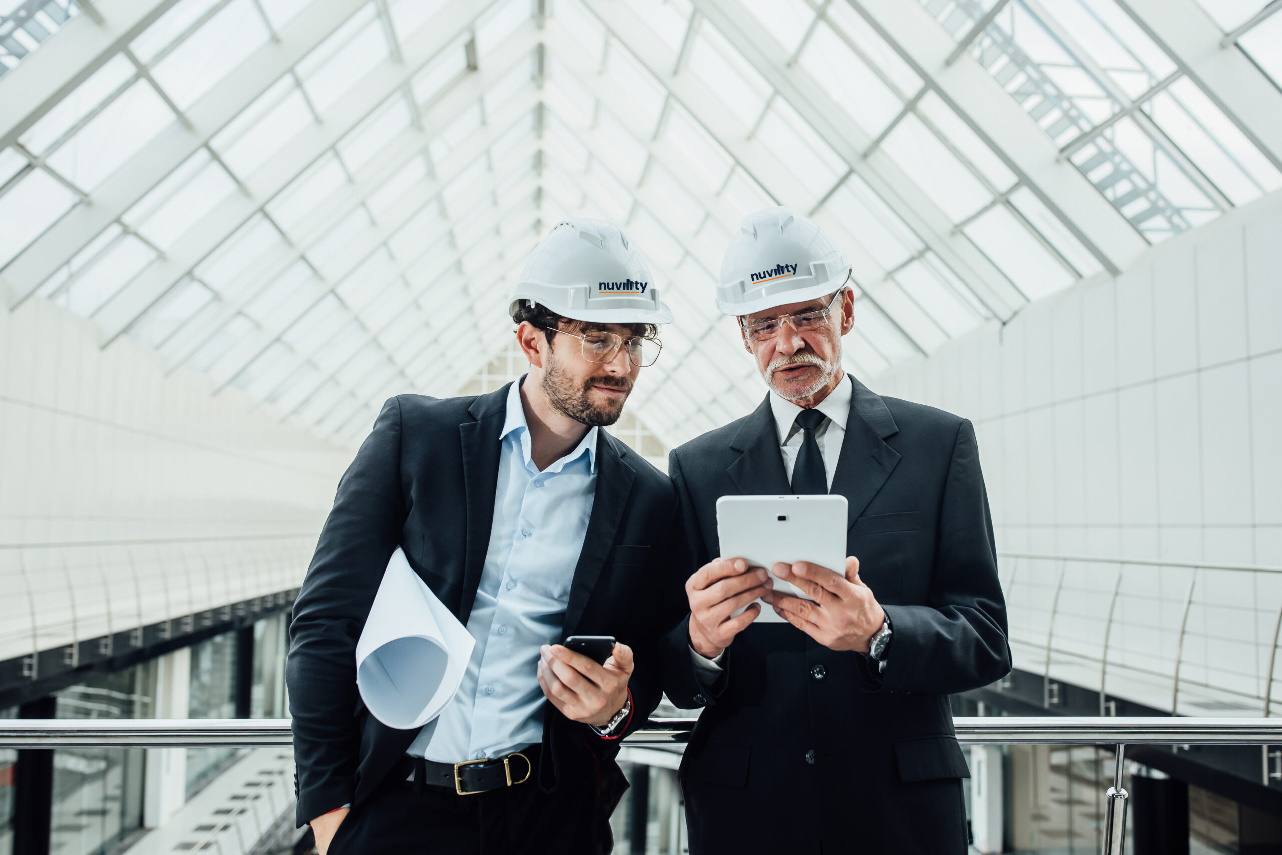 Two successful entrepreneur in helmet with project and laptop of